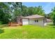 Exterior view of home and deck with green lawn and partial fencing at 381 Warner Se St, Marietta, GA 30060