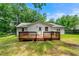 Exterior backyard of home with deck and partial fencing surrounded by trees at 381 Warner Se St, Marietta, GA 30060