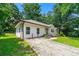 Charming single-story home with a well-maintained lawn, a concrete driveway, and surrounded by lush trees at 381 Warner Se St, Marietta, GA 30060