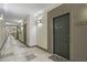 Long hallway of a building leading to apartments with neutral walls and gray doors at 401 16Th Nw St # 1357, Atlanta, GA 30363