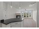 Open living space with bar top and light fixtures flowing into the living room at 401 16Th Nw St # 1357, Atlanta, GA 30363