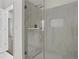 Modern shower featuring marble wall, shower head and elegant glass door at 401 16Th Nw St # 1357, Atlanta, GA 30363