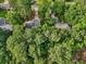 Overhead shot of the home nestled within a canopy of green trees, showcasing the roof and surrounding landscape at 4363 Old Mabry Road Northeast Ne Rd, Roswell, GA 30075