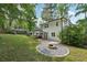 A large backyard featuring an outdoor gazebo, fire pit, lush lawn and privacy fence at 4363 Old Mabry Road Northeast Ne Rd, Roswell, GA 30075