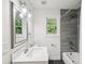 Bright bathroom featuring modern fixtures, gray shower tiles, and a white vanity with a chrome faucet at 4363 Old Mabry Road Northeast Ne Rd, Roswell, GA 30075