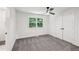 Clean bedroom featuring neutral carpet, closet, ceiling fan, and a large window providing natural light at 4363 Old Mabry Road Northeast Ne Rd, Roswell, GA 30075