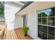 Close up of a charming front porch with wooden deck and white siding at 4363 Old Mabry Road Northeast Ne Rd, Roswell, GA 30075
