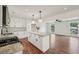 Renovated kitchen with granite counters, island with pendant lights, and open floorplan concept at 4363 Old Mabry Road Northeast Ne Rd, Roswell, GA 30075