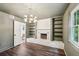 Charming living room with stone fireplace, built-in shelves, hardwood floors, and a bright window at 4363 Old Mabry Road Northeast Ne Rd, Roswell, GA 30075
