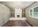 Cozy living room featuring a stone fireplace, built-in shelves, and hardwood floors at 4363 Old Mabry Road Northeast Ne Rd, Roswell, GA 30075
