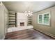 Cozy living room with a stone fireplace, built-in shelves, and stylish chandelier at 4363 Old Mabry Road Northeast Ne Rd, Roswell, GA 30075