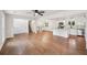 Spacious living room boasts gleaming hardwood floors, white walls, and seamless flow into a modern kitchen at 4363 Old Mabry Road Northeast Ne Rd, Roswell, GA 30075