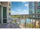 Relaxing balcony area with seating overlooking a sparkling community pool and lush landscaping at 943 Peachtree Ne St # 902, Atlanta, GA 30309