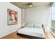 Cozy bedroom offers ample natural light and a modern ceiling fan at 943 Peachtree Ne St # 902, Atlanta, GA 30309