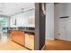 Functional kitchen area with wood cabinets, granite counters and stainless dishwasher with open-concept living space at 943 Peachtree Ne St # 902, Atlanta, GA 30309
