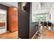 View of a stylish kitchenette featuring wooden cabinets and a glimpse into a well-lit bathroom at 943 Peachtree Ne St # 902, Atlanta, GA 30309