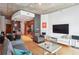 Open-concept living room with modern furnishings, hardwood floors, and an adjacent kitchen area at 943 Peachtree Ne St # 902, Atlanta, GA 30309