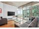 Comfortable living room with modern furnishings, hardwood floors, and stunning city views at 943 Peachtree Ne St # 902, Atlanta, GA 30309