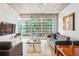 Bright living room features hardwood floors, large windows, and modern decor at 943 Peachtree Ne St # 902, Atlanta, GA 30309