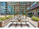 Comfortable outdoor lounge area with seating around a modern fire pit and lush landscaping at 943 Peachtree Ne St # 902, Atlanta, GA 30309