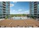 Resort-style pool surrounded by lounge chairs and lush landscaping between condominium buildings at 943 Peachtree Ne St # 902, Atlanta, GA 30309