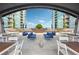 Inviting rooftop deck with comfortable seating, tables, and a view of the surrounding buildings at 943 Peachtree Ne St # 902, Atlanta, GA 30309