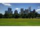 Picturesque skyline view of Atlanta visible beyond a lush green park under a clear blue sky at 943 Peachtree Ne St # 902, Atlanta, GA 30309