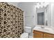 Well-lit bathroom featuring a shower with decorative curtain, toilet, and vanity with sink at 3044 Lauren Parc Rd, Decatur, GA 30032