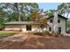 Spacious backyard features deck with patio seating, fire pit, and mature trees at 3480 Tanbark Ne Ct, Brookhaven, GA 30319