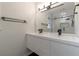 Modern bathroom featuring double vanity sinks, black fixtures, glass-enclosed shower and sleek lighting at 3480 Tanbark Ne Ct, Brookhaven, GA 30319