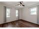 Bright bedroom with hardwood floors, ceiling fan, neutral paint and two windows with lovely trim at 3480 Tanbark Ne Ct, Brookhaven, GA 30319