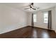 Bright bedroom with hardwood floors, ceiling fan, and windows letting in natural light at 3480 Tanbark Ne Ct, Brookhaven, GA 30319
