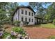 Two-story home exterior with beautiful landscaping, black trim, and covered porch at 3480 Tanbark Ne Ct, Brookhaven, GA 30319