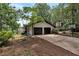 Home exterior displaying attached two-car garage and lush landscaping at 3480 Tanbark Ne Ct, Brookhaven, GA 30319
