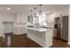 Stylish kitchen with white cabinets, stainless steel appliances, a center island and modern lighting at 3480 Tanbark Ne Ct, Brookhaven, GA 30319