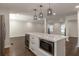 Open-concept kitchen island featuring bar seating, modern appliances, and views of the living space at 3480 Tanbark Ne Ct, Brookhaven, GA 30319