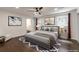 Well-lit bedroom featuring a ceiling fan, wood floors, and a view of the bathroom at 3480 Tanbark Ne Ct, Brookhaven, GA 30319