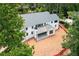 Rear view of a modern, white home with a covered porch and ample green space at 3118 Lanier Ne Dr, Brookhaven, GA 30319