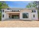 Modern home with brick, a covered patio, a level lawn, and lots of windows at 3118 Lanier Ne Dr, Brookhaven, GA 30319
