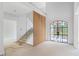 Bright and spacious foyer featuring wood slat accent wall, staircase and black window at 3118 Lanier Ne Dr, Brookhaven, GA 30319
