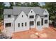 Beautiful white home featuring a three-car garage and gray roof at 3118 Lanier Ne Dr, Brookhaven, GA 30319