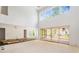 Spacious living room with soaring ceilings, fireplace, and large sliding glass doors for indoor-outdoor living at 3118 Lanier Ne Dr, Brookhaven, GA 30319