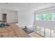 Upstairs view of the living room with high ceilings and large windows, ready for new flooring at 3118 Lanier Ne Dr, Brookhaven, GA 30319