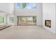 Bright living room with fireplace, large windows, and sliding glass doors to the backyard at 3118 Lanier Ne Dr, Brookhaven, GA 30319