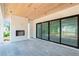 Outdoor patio with a wood-paneled ceiling, a brick fireplace, and sliding glass doors to the yard at 3118 Lanier Ne Dr, Brookhaven, GA 30319