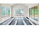 Bright sunroom with natural light and planks ready for flooring installation, and many windows at 3118 Lanier Ne Dr, Brookhaven, GA 30319