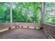 Wood deck featuring built in benches overlooking tree filled backyard at 6708 Bedford Rd, Rex, GA 30273