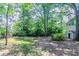 Exterior showcasing the home's shady backyard with a shed at 6708 Bedford Rd, Rex, GA 30273