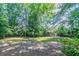 A spacious backyard shaded by mature trees provides a serene outdoor retreat at 6708 Bedford Rd, Rex, GA 30273