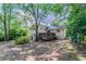 Exterior showcasing a home's backyard with a wooden deck and shed at 6708 Bedford Rd, Rex, GA 30273